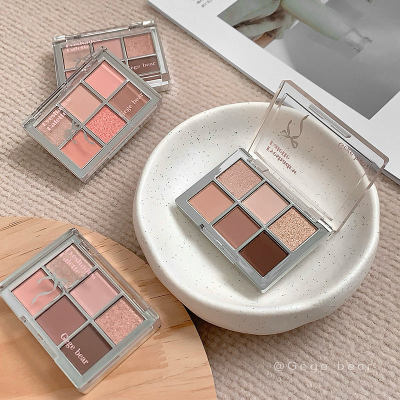 Makeup eyeshadow palettes on a textured surface