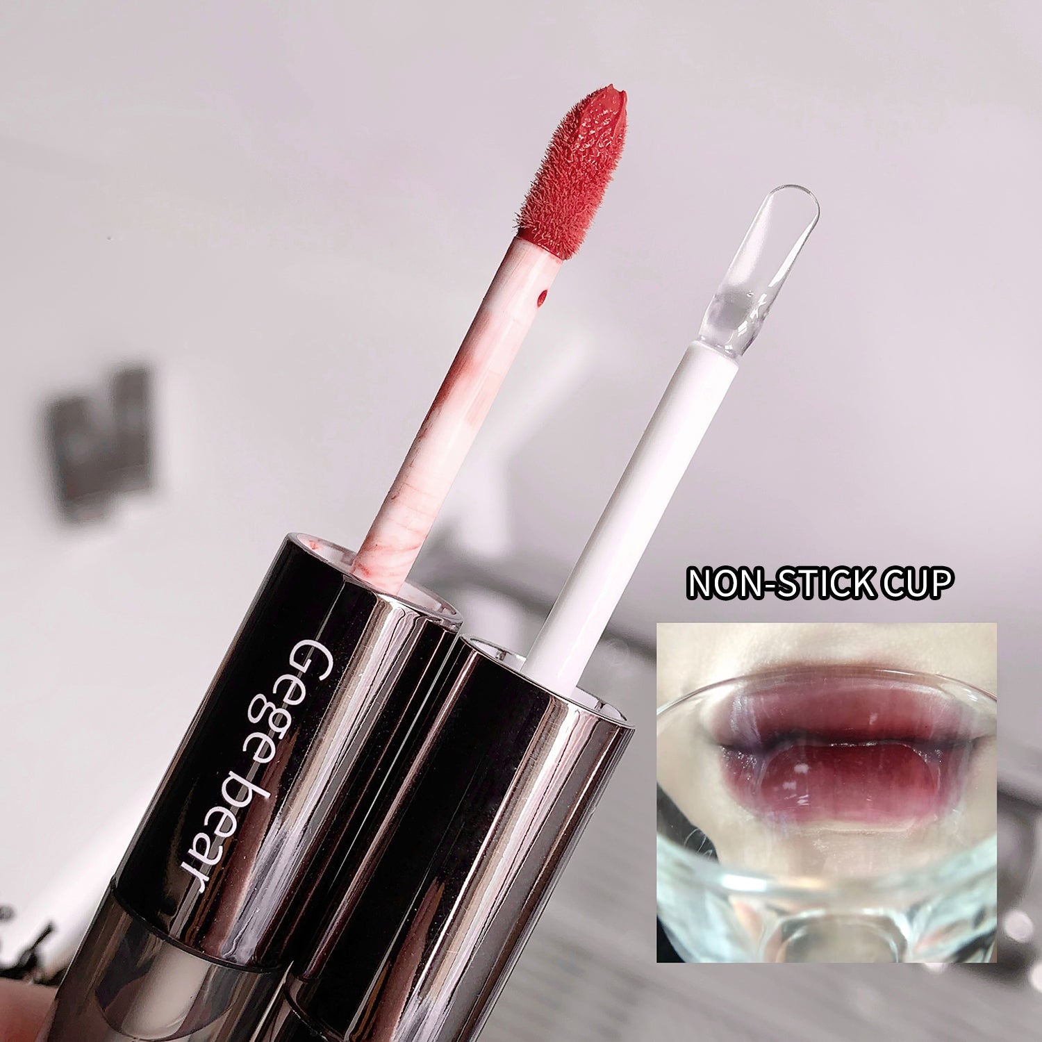 Lip gloss with a non-stick cup feature on a gray background