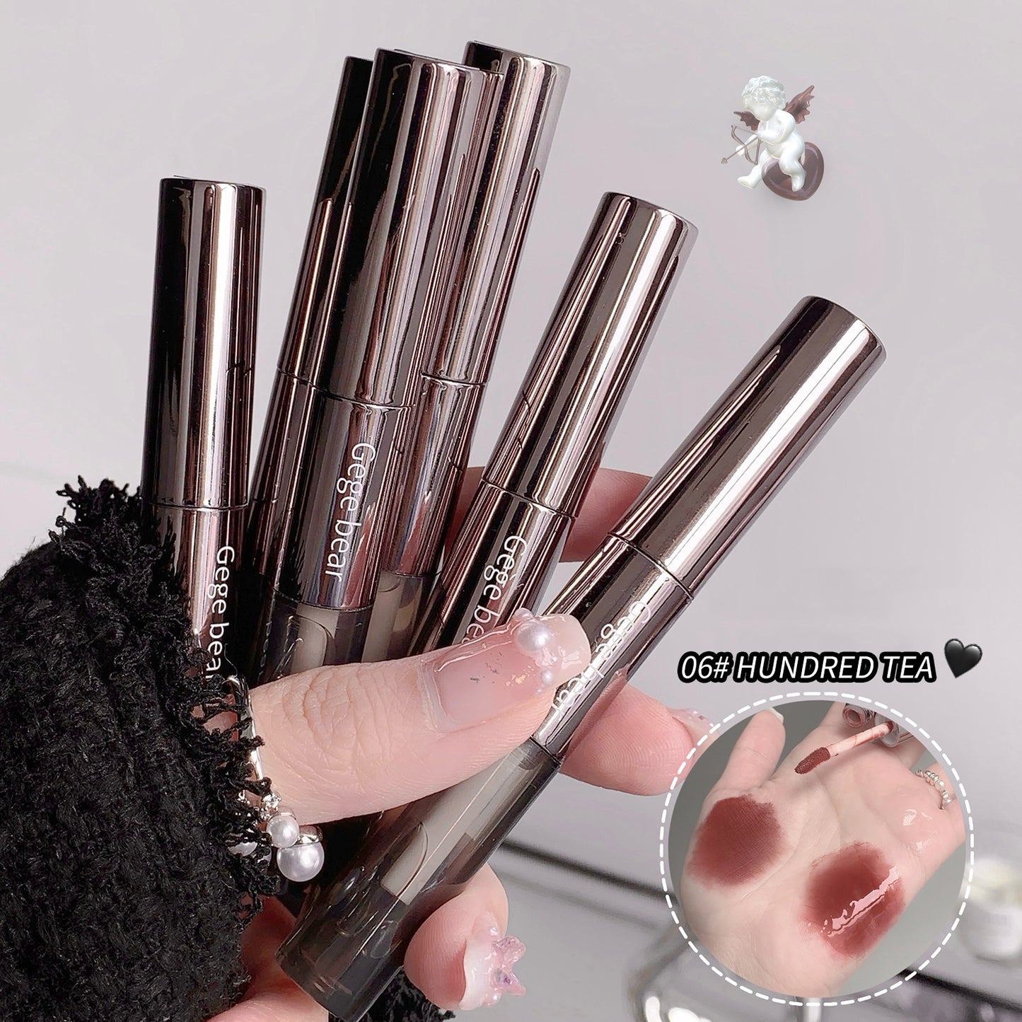 Lipstick applicators held by a hand with a close-up of lipstick application on skin.