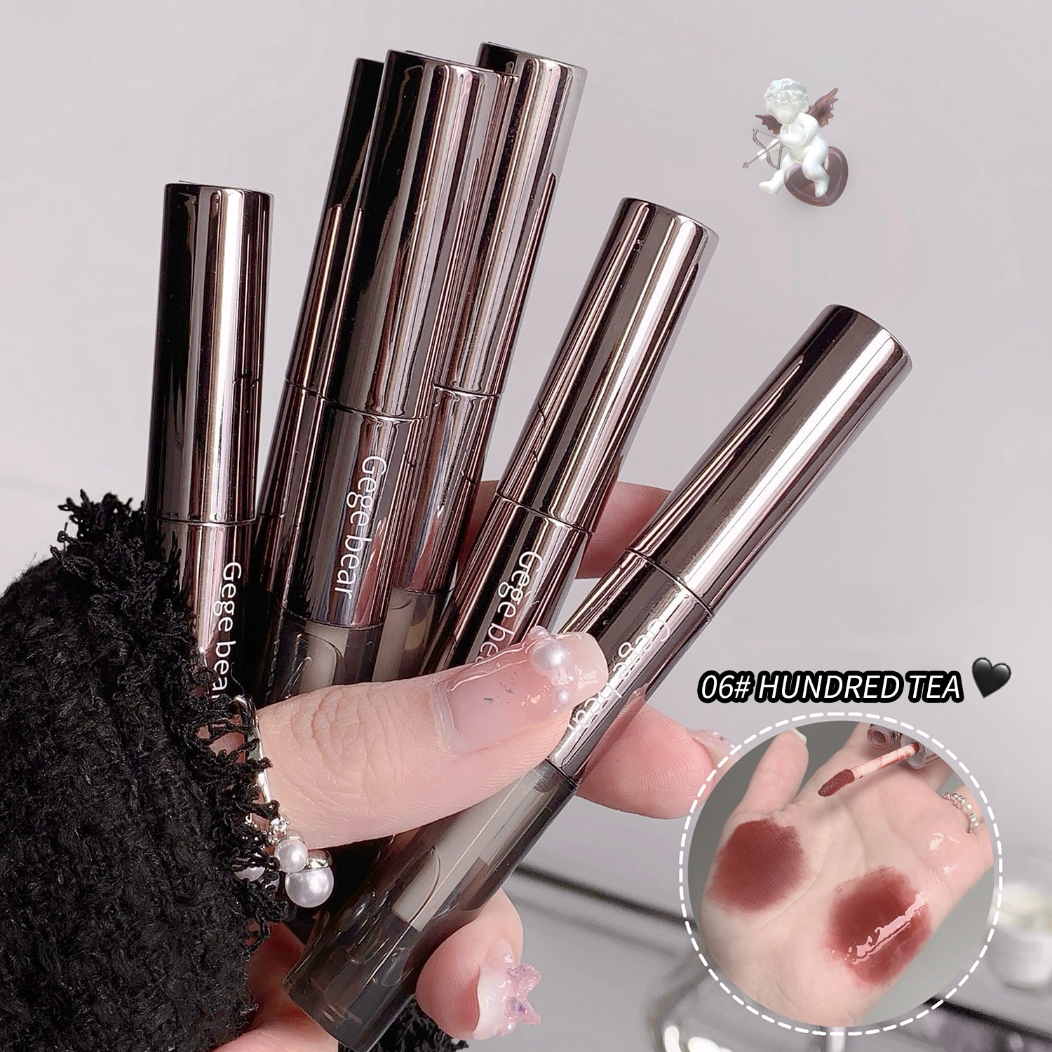 Lipstick applicators held by a hand with a close-up of lipstick application on skin.