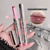 Two lipsticks with pink caps and silver bodies, one being held by a hand, on a neutral background.