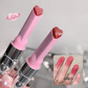 Two pink lip-shaped products with a close-up of lips wearing red lipstick on a gray background.