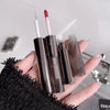 Hand holding makeup products including lipsticks and a lip liner on a blurred background