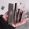 Hand holding lip products with 'Gigebear' branding against a neutral background