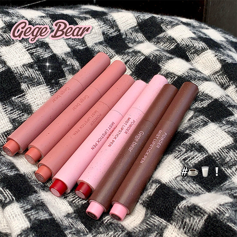 Set of lipsticks in various shades on a checkered fabric background with 'Gege Bear' branding.
