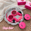 Pink makeup set with a silver tray on a textured surface, featuring 'Gege bear' branding.