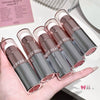 Set of GE GE BEAR lipsticks held in a hand with a blurred background