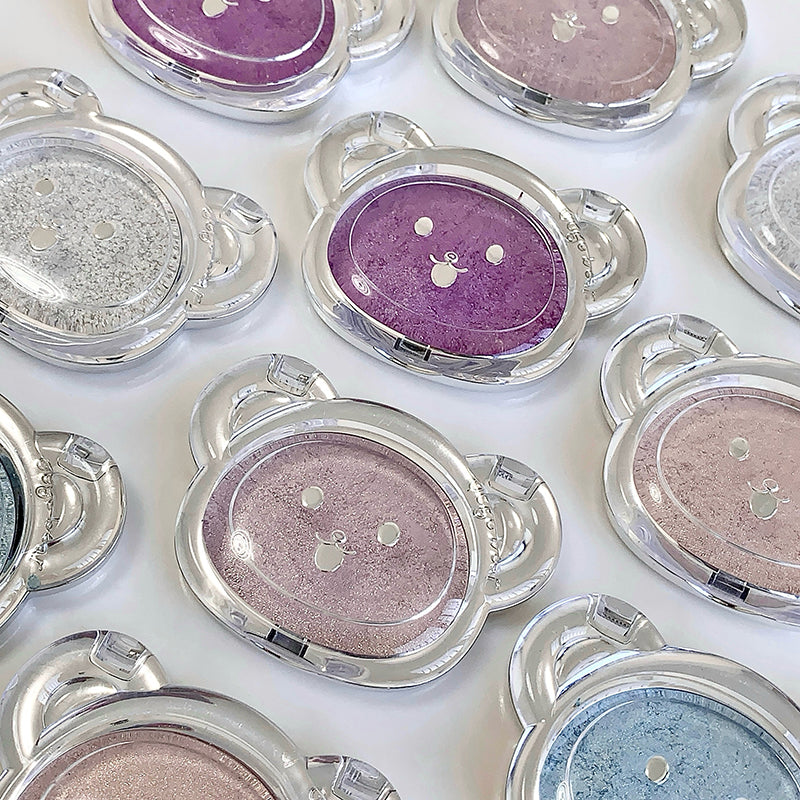Multiple compact powder cases with various colors on a white background