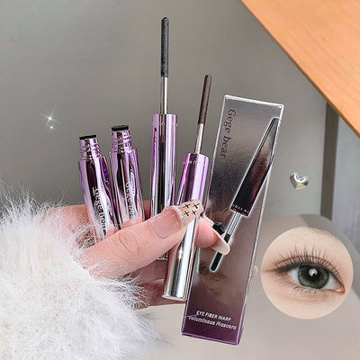 Eyebrow pencil with packaging held by a hand, close-up of an eye with long eyelashes.