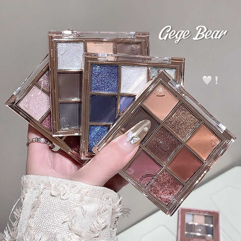Makeup eyeshadow palettes held by a hand with a blurred background