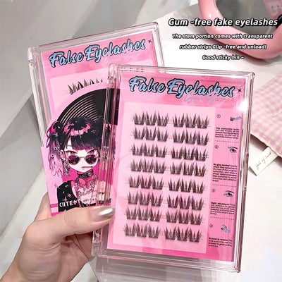 False eyelashes packaging with pink and black design, held by a hand.