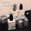 Cosmetic bottles with 'GEGE BEAR' branding on a dark surface.