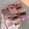 Multiple open makeup compact cases with colorful shades held together.