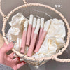 Set of pink lipsticks in a decorative basket with white fabric