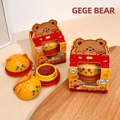 Two GEGE BEAR toys with their packaging on a wooden surface.