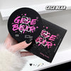 Hand holding a GEGE BEAR setting powder compact with packaging on a white surface.