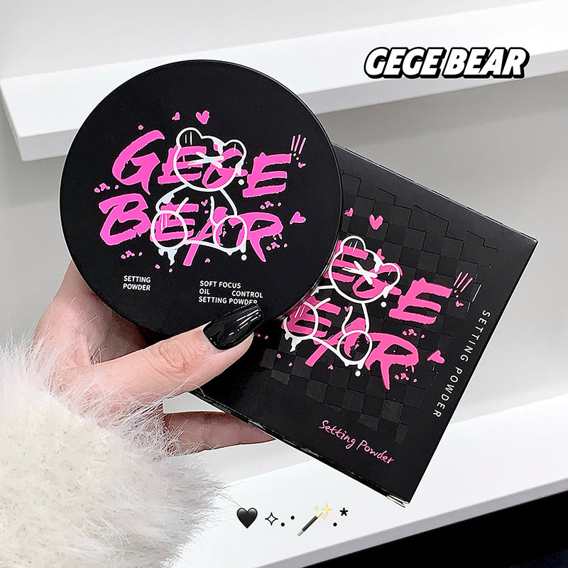 Hand holding a GEGE BEAR setting powder compact with packaging on a white surface.