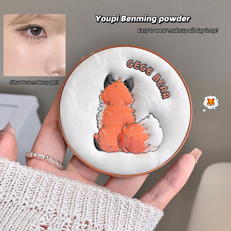 Makeup compact with a fox design and 'GEGE BEAR' text, held by a person.