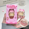 Gege Bear lip oil with packaging and close-up of the product on a blurred background