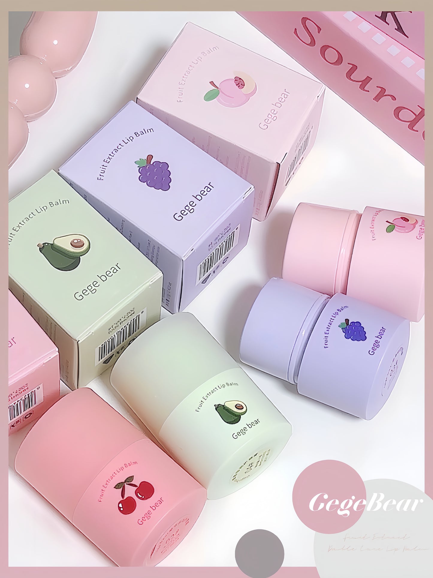 Collection of Gege Bear lip balms and packaging on a light pink background