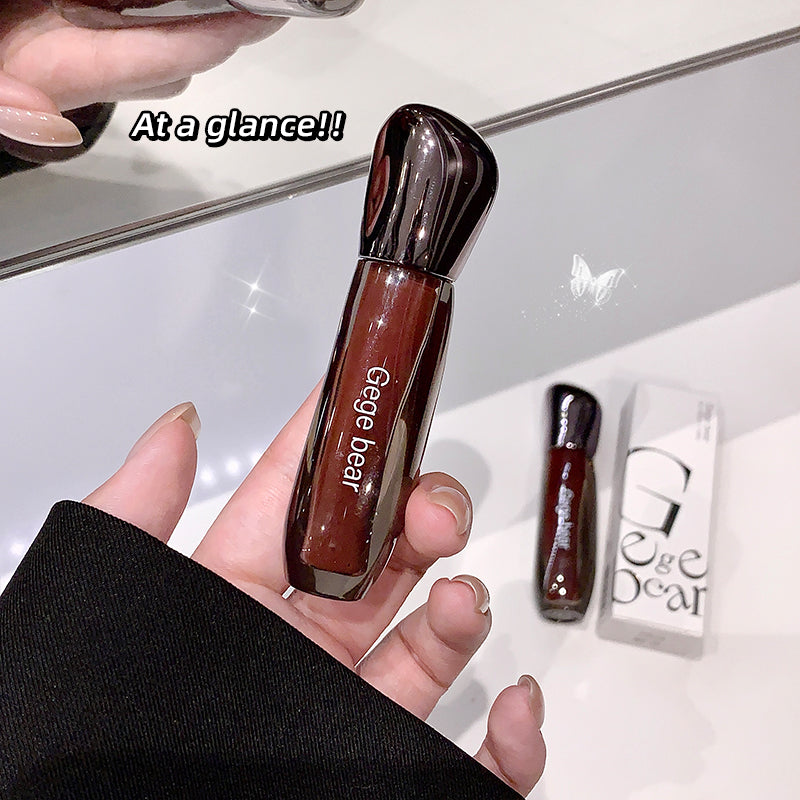 Brown lip gloss held in a hand with 'Gege Bear' branding, against a white background.