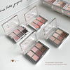 Set of open eyeshadow palettes with a neutral color palette on a light background.