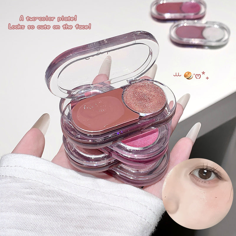 Two-color makeup palette held by a hand with a close-up of an eye wearing the product.