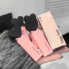 Pink lip balm with black heart-shaped ends held by a person, with 'Gegebear' packaging.
