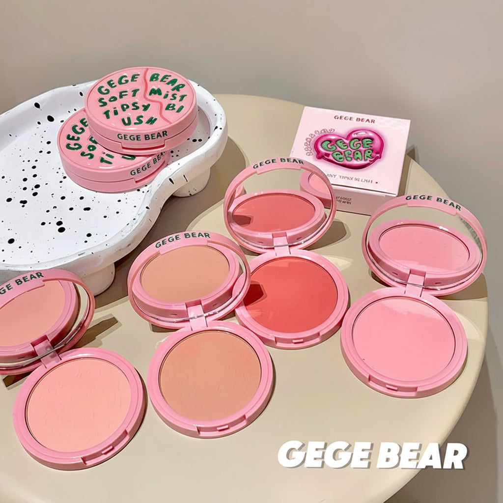 Pink makeup products with 'GECE BEAR' branding on a light surface.