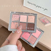 Makeup palette with pink and brown shades held by a hand, brand 'GEGE BEAR' visible.
