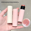 Three lip balm sticks held in a hand with an inset showing the texture of the lip balm.