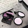 Makeup compact with pink powder and 'Gisele Bear' branding on a decorative surface.