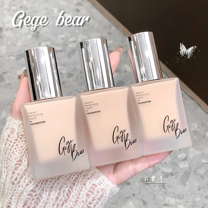 Three Gege Bear foundation bottles held in a hand with a blurred background