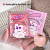 Two pink GEGE BEAR makeup products held by a hand, with a close-up of peach-colored skin.