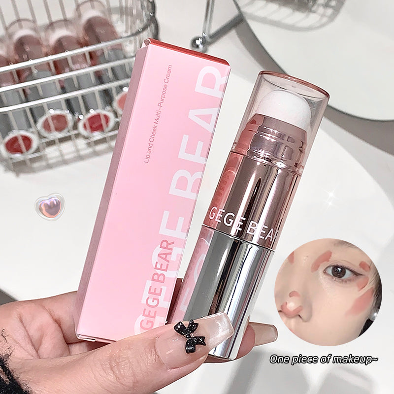Lipstick with pink case held by a hand, with 'GEGE BEAR' branding.