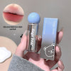 Lip balm with blue cap and clear container held by a hand, next to its packaging and close-up of lips.