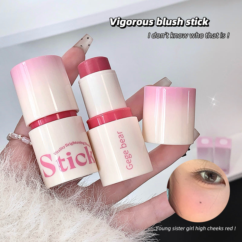 Two Gege Bear blush sticks held by a hand with a blurred face inset.