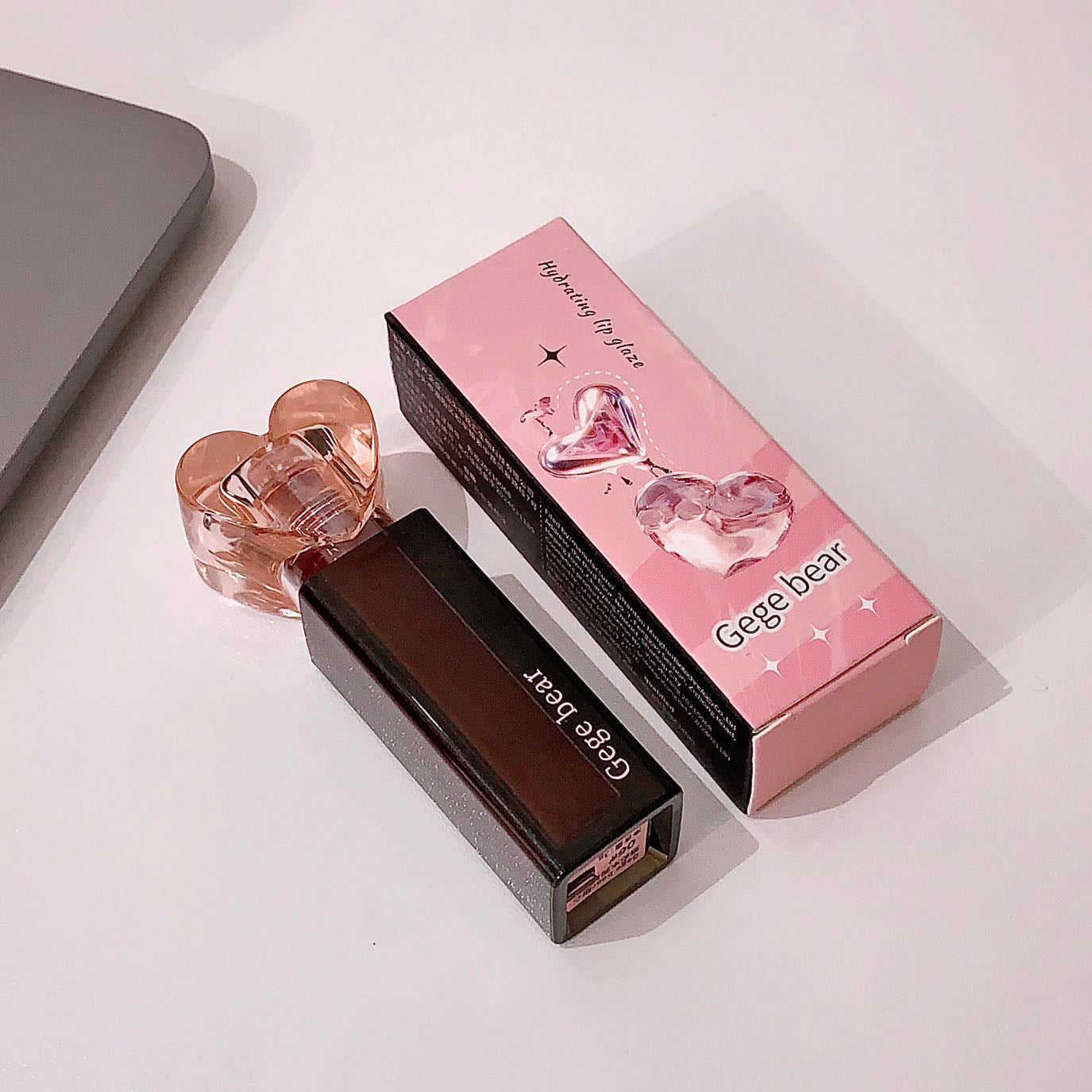 Lipstick and packaging with 'Gege bear' branding on a light background