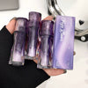 Hand holding four Gege Bear makeup products with a blurred background