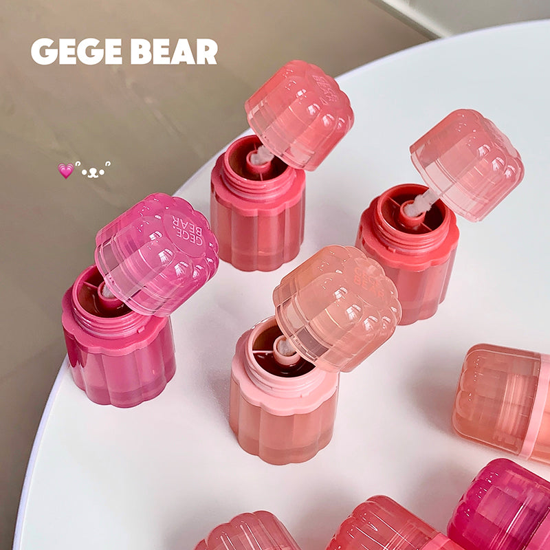 Pink lip balm containers with 'GEGE BEAR' branding on a white surface.