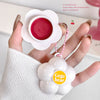 Hand holding a white cosmetic tool with pink contents, branded 'Gegebear', on a light background.