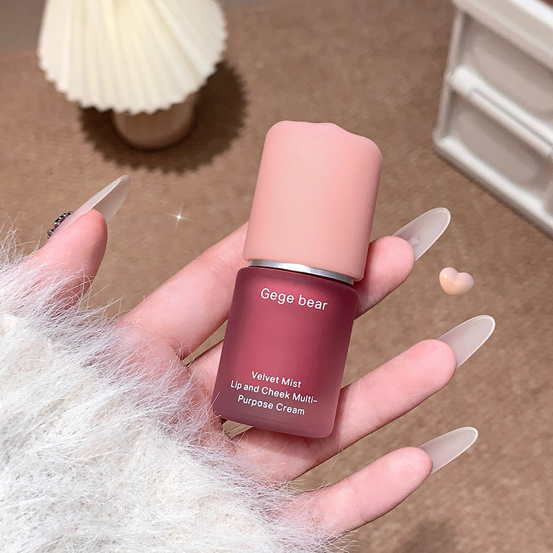 Hand holding a Gege bear cosmetic product with a blurred background