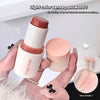 Hand holding a Gege bear makeup stick with close-up of color swatch on a light background