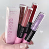 GEGE BEAR lip glosses held by a hand against a light gray background