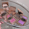 Makeup products with glittery shades on a metal tray, branded 'Gege Bear'.