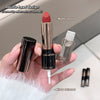 Hand holding a matte lipstick and mirror raincoat with product details on a neutral background