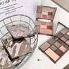 Makeup palettes with a decorative box on a white surface