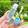 Hand holding a small cosmetic bottle with a brush and container outdoors