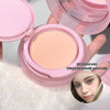 Compact powder in a pink case with a close-up of a person wearing it.