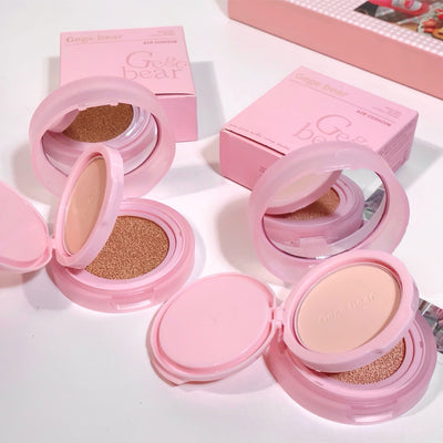 Pink compact powder with open cases on a white background
